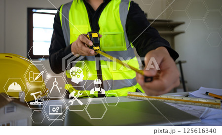 Construction worker using measuring tape with digital innovation and smart industry technology Construction worker using measuring tape with digital innovation and smart industry technology 125616340