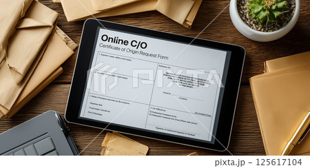Online certificate of origin request form displayed on digital tablet with envelope and cactus 125617104