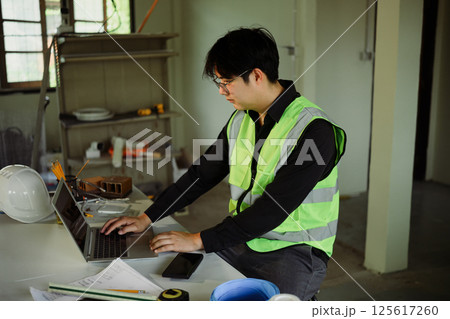 Site supervisor reviewing plans and data in a renovation zone Site supervisor reviewing plans and data in a renovation zone 125617260