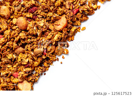 Granola texture on a white background, with copy space. Organic gourmet muesli Granola texture on a white background, with copy space. Organic gourmet muesli 125617523