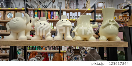 Shop of decorative goods and interior accessories. Exhibition racks with a wide range of interior products. 125617844