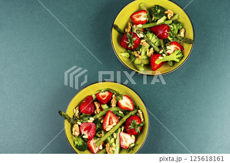 Green mixed salad with green asparagus and strawberries. Green mixed salad with green asparagus and strawberries. 125618161