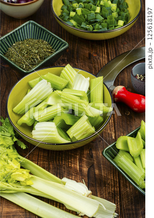 Cut raw celery stalks. Cut raw celery stalks. 125618197