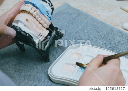 Mastering the art of ceramic denture creation in a dental lab setting Mastering the art of ceramic denture creation in a dental lab setting 125618327