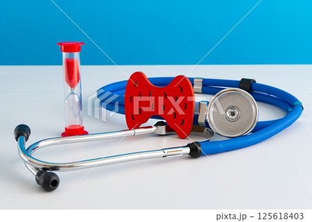 Anatomical model human thyroid gland closeup with hourglass and stethoscope Anatomical model human thyroid gland closeup with hourglass and stethoscope 125618403