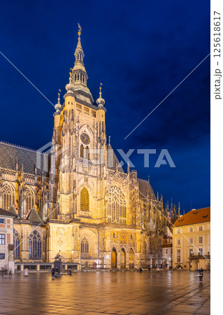St Vitus Cathedral shines brightly under the night sky, showcasing its gothic architecture. Located in Prague Castle, the scene captures the serene atmosphere of the location. St Vitus Cathedral shines brightly under the night sky, showcasing its gothic architecture. Located in Prague Castle, the scene captures the serene atmosphere of the location. 125618617