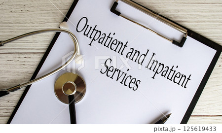 Top view of Outpatient and Inpatient text on clipboard with gavel on top. Medical support concept 125619433
