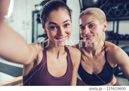Pretty smiling caucasian women making selfie in the gym Pretty smiling caucasian women making selfie in the gym 125619600