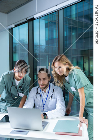 Doctors practitioners in hospital discussing care plan using digital tools Doctors practitioners in hospital discussing care plan using digital tools 125619691