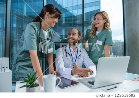 Medical team working together in office using laptop for discussing diagnosis 125619692