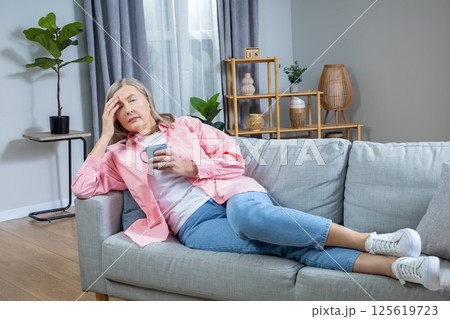 Menopausal woman suffering from a headache and feeling unwell 125619723