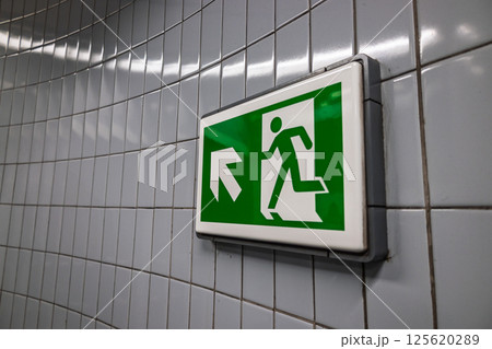 Green emergency exit sign with running man icon 125620289