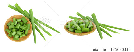 Green onion in wooden bowl isolated on the white background. Top view. Flat lay. Green onion in wooden bowl isolated on the white background. Top view. Flat lay. 125620333