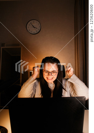 Young businesswoman looking at computer screen and seeing first sales of her small business. Exciting and happy Caucasian woman with laptop. New entrepreneur selling products. Young businesswoman looking at computer screen and seeing first sales of her small business. Exciting and happy Caucasian woman with laptop. New entrepreneur selling products. 125620600