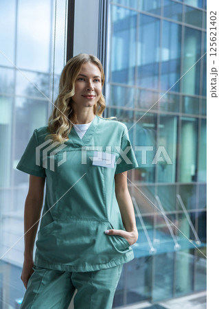 Caucasian doctor in hospital wearing uniform working in healthcare office 125621402