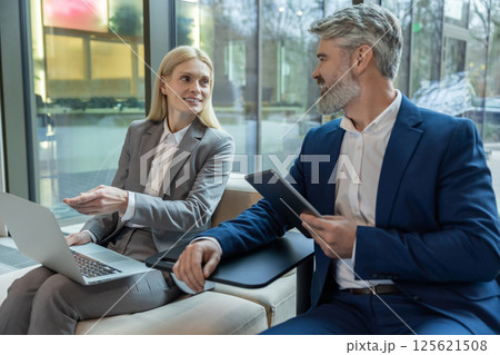 Executive and entrepreneur speaking together about business strategy with laptop and tablet Executive and entrepreneur speaking together about business strategy with laptop and tablet 125621508