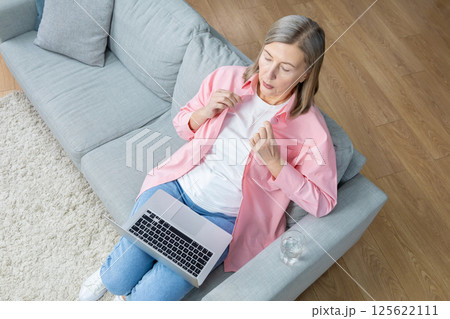 Top view of a woman sitting on the sofa with a laptop 125622111