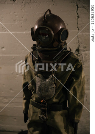 A diver stands in a diving suit before diving A diver stands in a diving suit before diving 125622959