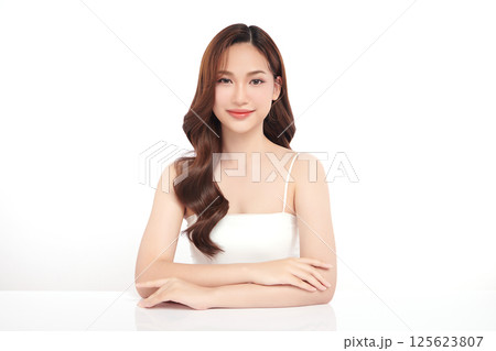 A beautiful young Asian woman with clean, fresh skin against a white background. Skincare, facial treatment, cosmetology, beauty, and spa. An elegant portrait of an Asian woman. A beautiful young Asian woman with clean, fresh skin against a white background. Skincare, facial treatment, cosmetology, beauty, and spa. An elegant portrait of an Asian woman. 125623807