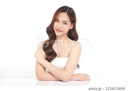 A beautiful young Asian woman with clean, fresh skin against a white background. Skincare, facial treatment, cosmetology, beauty, and spa. An elegant portrait of an Asian woman. 125623809