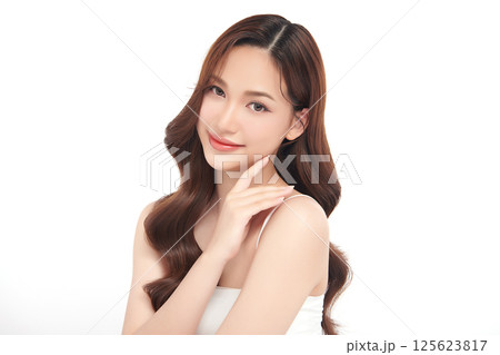 A beautiful young Asian woman with clean, fresh skin against a white background. Skincare, facial treatment, cosmetology, beauty, and spa. An elegant portrait of an Asian woman. A beautiful young Asian woman with clean, fresh skin against a white background. Skincare, facial treatment, cosmetology, beauty, and spa. An elegant portrait of an Asian woman. 125623817