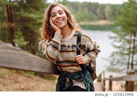 Attractive young woman enjoying fresh air on the lake. Travel, Hiking, nature Attractive young woman enjoying fresh air on the lake. Travel, Hiking, nature 125623906