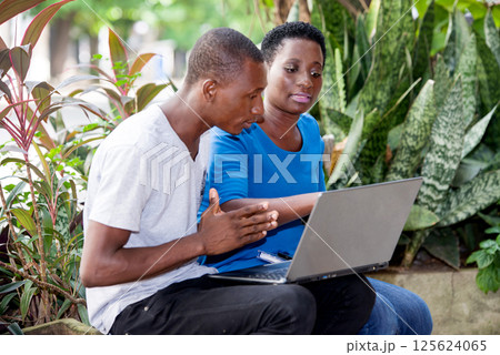 portrait of young students sitting with laptop. 125624065