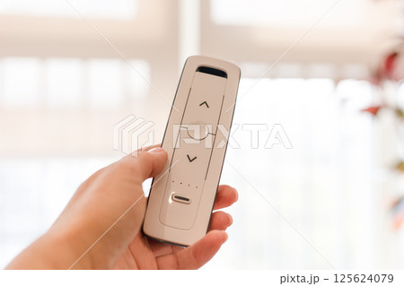 Radio remote control for blinds and roller shades, white, close-up. 125624079
