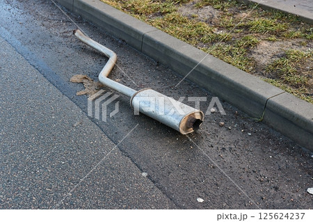Exhaust pipe fallen of a junker car 125624237