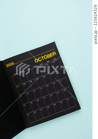 October 2026 Black calendar opening on blue background. October 2026 Black calendar opening on blue background. 125624329