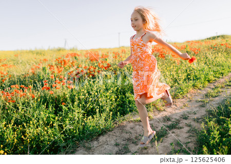 Girl running outdoor countryside. Lifestyle girl with sunshine in field 125625406