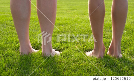 Barefoot walking, summer grass, barefoot relaxation in nature. Soft green lawn, feet touch, outdoor wellness. Bare feet connect with summer, park recreation, healthy lifestyle, peaceful garden, Barefoot walking, summer grass, barefoot relaxation in nature. Soft green lawn, feet touch, outdoor wellness. Bare feet connect with summer, park recreation, healthy lifestyle, peaceful garden, 125625610