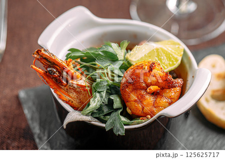 Portion of delicacy royal shrimp with toasted bread Portion of delicacy royal shrimp with toasted bread 125625717
