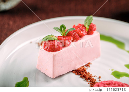 Portion of pink raspberry mousse dessert 125625718