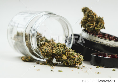 Medical marijuana buds with grinder on white background, close up. Medical marijuana buds with grinder on white background, close up. 125626274