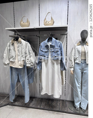 Stylish clothing display featuring denim and casual wear in a modern boutique 125626285