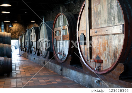 Barrels in wine cellar 125626593