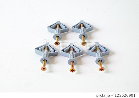 Grey Butterfly type plastic dowel on white background. Grey Butterfly type plastic dowel on white background. 125626901