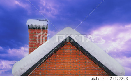 Roof and brick chimney covered with snow in winter 125627298