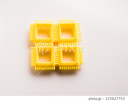 Yellow parts of a children's construction set. Puzzle for children, Yellow parts of a children's construction set. Puzzle for children, 125627753