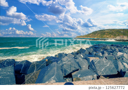 Landscape with sea and cliffs. Rocky seashore on a sunny day. Beautiful nature landscape. Stormy sea. San Sebastian, Basque Country, Spain Landscape with sea and cliffs. Rocky seashore on a sunny day. Beautiful nature landscape. Stormy sea. San Sebastian, Basque Country, Spain 125627772