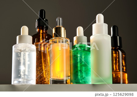 Lots of different face serums in the sun. 125629098