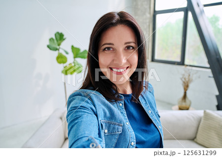 Selfie portrait happy beautiful woman in home interior Selfie portrait happy beautiful woman in home interior 125631299