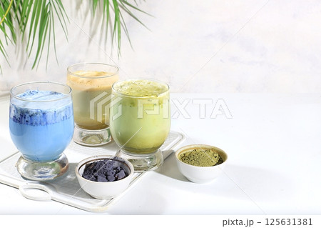 Assortment of colorful Japanese tea latte with milk, green, blue, pink moon milk, golden milk. Fashionable healthy drink has anti-inflammatory properties, promotes weight loss, selective focus Assortment of colorful Japanese tea latte with milk, green, blue, pink moon milk, golden milk. Fashionable healthy drink has anti-inflammatory properties, promotes weight loss, selective focus 125631381