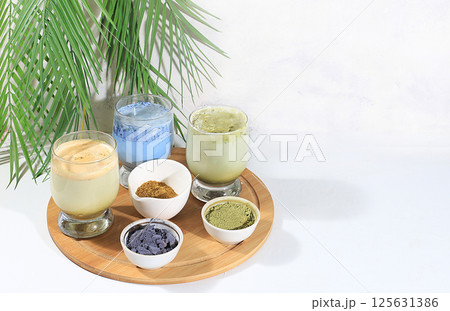 Assortment of colorful Japanese tea latte with milk, green, blue, pink moon milk, golden milk. Fashionable healthy drink has anti-inflammatory properties, promotes weight loss, selective focus 125631386