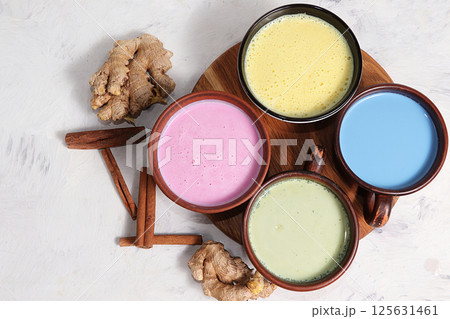 An assortment of colorful latte Japanese tea, golden turmeric, matcha, blue, pink moon milk. It has anti-inflammatory properties, improves immunity, alternative medicine An assortment of colorful latte Japanese tea, golden turmeric, matcha, blue, pink moon milk. It has anti-inflammatory properties, improves immunity, alternative medicine 125631461
