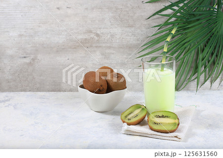 Indian yogurt Lassi with kiwi and spices, on the old grunge background, probiotic fermented milk drink, natural diet food, helps to lose weight and reduce body weight, selective focus 125631560