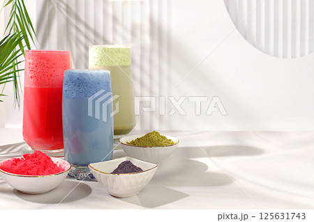 Assortment of various matcha tea latte with milk on elegant kitchen sunny background and matcha powder. Traditional Indian drink rich in antioxidants used for weight loss and treatmen Assortment of various matcha tea latte with milk on elegant kitchen sunny background and matcha powder. Traditional Indian drink rich in antioxidants used for weight loss and treatmen 125631743