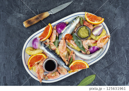 Plate with marinated seafood. 125631961