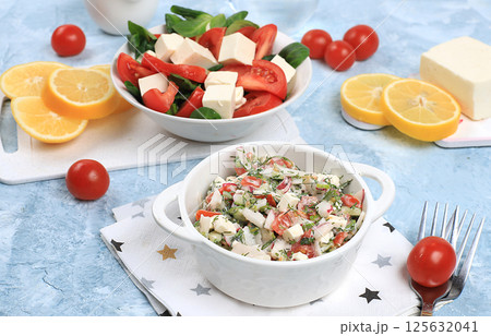 Vegetable salad with mozzarella cheese, cherry tomatoes and fresh arugula, Healthy natural breakfast with lemon, detox diet. Traditional Italian food, cholesterol and GMO free, selective focus, space 125632041